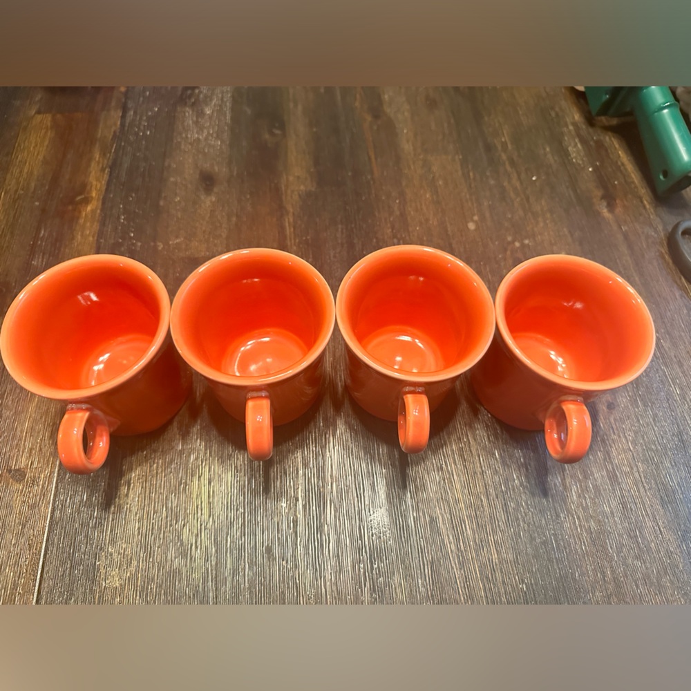 Like NEW set of 4 Fiestaware mugs.  Beautiful reddish orange color.